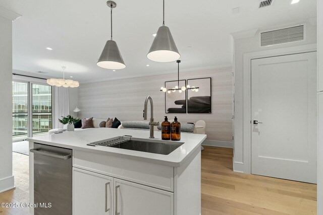 19 Washington St Unit 552P, Saratoga Springs, Inside, NY 12866 - kitchen with open floor plan, stainless steel dishwasher, an island with sink, light countertops, and hanging light fixtures