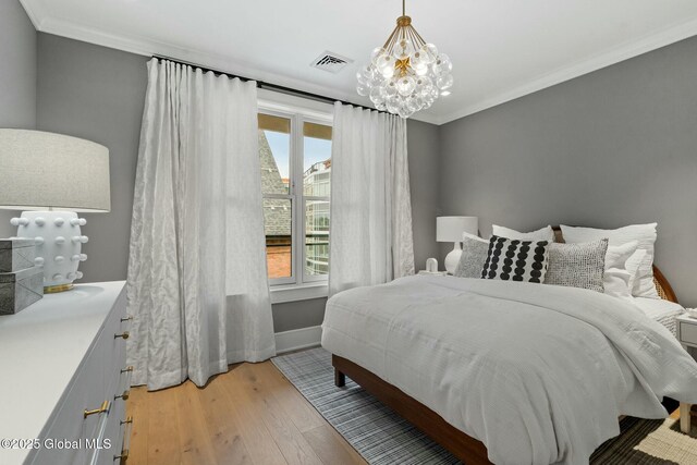 19 Washington St Unit 552P, Saratoga Springs, Inside, NY 12866 - bedroom with a chandelier, light wood-style floors, multiple windows, and crown molding
