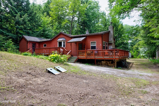 5761 Lake Rd, Galway, NY 12074 - view of front of property with a wooden deck, a chimney, and faux log siding