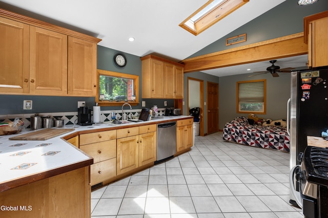 5761 Lake Rd, Galway, NY 12074 - kitchen featuring appliances with stainless steel finishes, tile countertops, lofted ceiling, a skylight, and light tile patterned floors