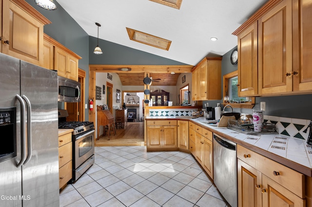 5761 Lake Rd, Galway, NY 12074 - kitchen featuring appliances with stainless steel finishes, tile counters, lofted ceiling, a skylight, and light tile patterned floors