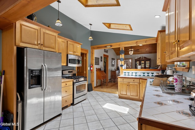 5761 Lake Rd, Galway, NY 12074 - kitchen featuring stainless steel appliances, tile countertops, a skylight, a peninsula, and light tile patterned floors