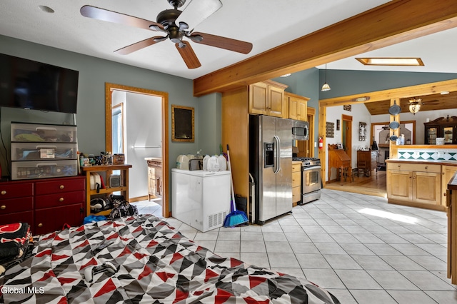 5761 Lake Rd, Galway, NY 12074 - kitchen with stainless steel appliances, washer and dryer, light tile patterned flooring, ceiling fan, and light brown cabinetry