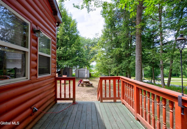 5761 Lake Rd, Galway, NY 12074 - deck with a storage unit and view of wooded area