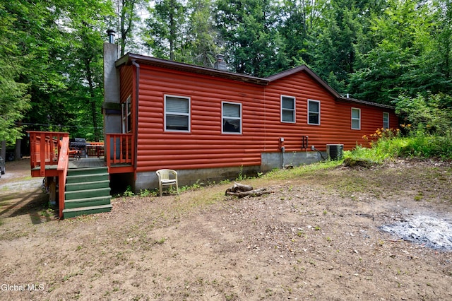 5761 Lake Rd, Galway, NY 12074 - view of side of home featuring a chimney, a deck, and log veneer siding