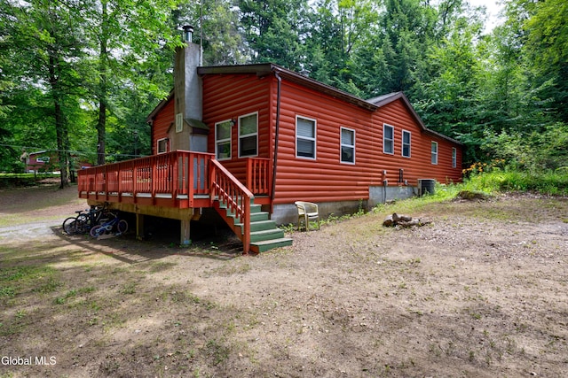 5761 Lake Rd, Galway, NY 12074 - view of side of property featuring a chimney, a wooden deck, and faux log siding