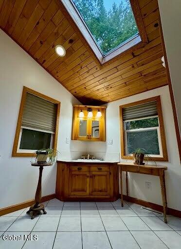 5761 Lake Rd, Galway, NY 12074 - bar area featuring wooden ceiling, vaulted ceiling, healthy amount of natural light, light tile patterned floors, and a skylight