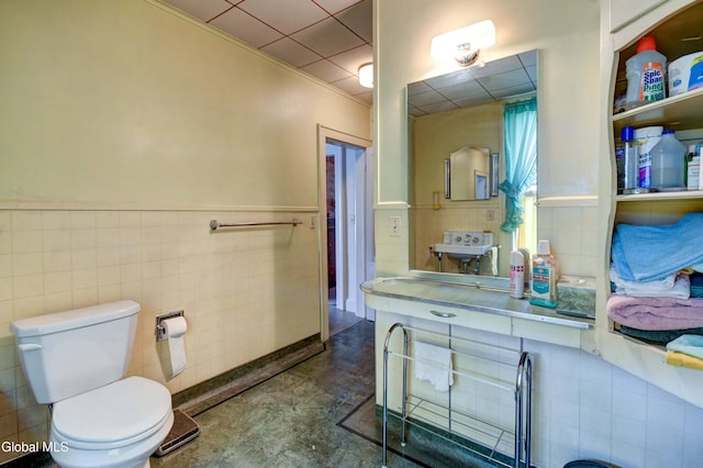 61 Mohawk St, Fort Plain, NY 13339 - bathroom featuring tile walls, finished concrete floors, wainscoting, and vanity