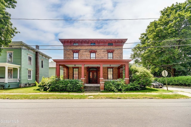 61 Mohawk St, Fort Plain, NY 13339 - italianate home featuring covered porch, brick siding, and a front yard