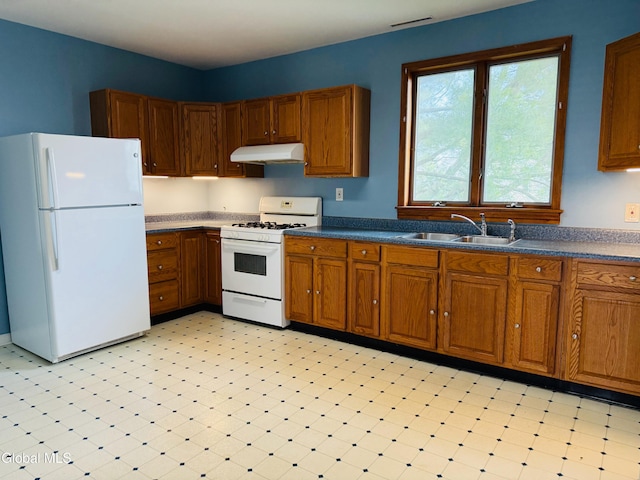 471-473 Harrison Ave, Schenectady, NY 12306 - kitchen featuring white appliances, under cabinet range hood, brown cabinets, and light floors