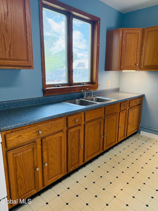 471-473 Harrison Ave, Schenectady, NY 12306 - kitchen with brown cabinetry, dark countertops, and light flooring