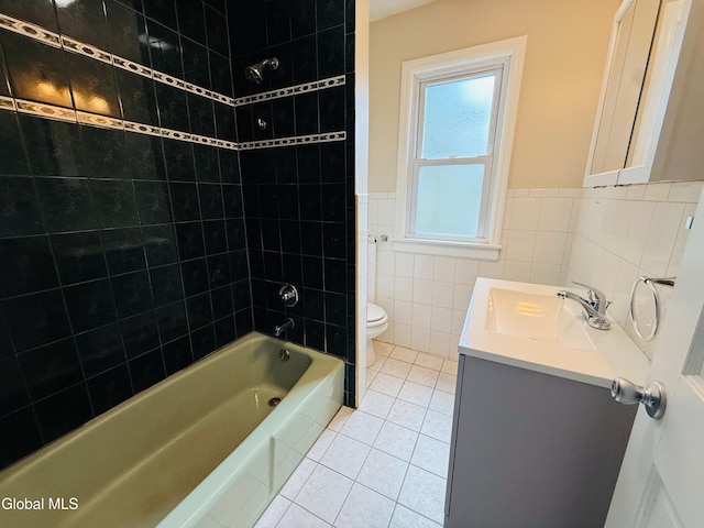 471-473 Harrison Ave, Schenectady, NY 12306 - full bath with vanity, tub / shower combination, tile patterned flooring, tile walls, and a wainscoted wall