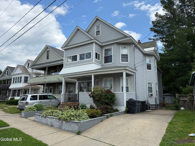 471-473 Harrison Ave, Schenectady, NY 12306 - view of front facade with a porch, concrete driveway, and cooling unit