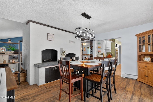 10 Heather Ln, Johnstown, NY 12078 - dining area with a baseboard heating unit, dark wood-style flooring, a textured ceiling, and a chandelier