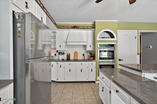10 Heather Ln, Johnstown, NY 12078 - kitchen featuring custom exhaust hood, appliances with stainless steel finishes, white cabinetry, open shelves, and a textured ceiling