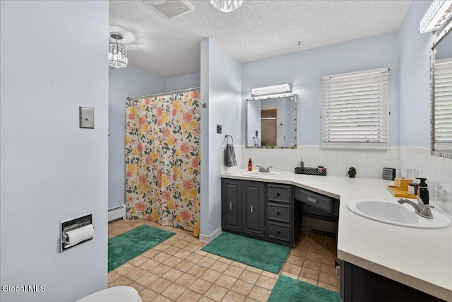10 Heather Ln, Johnstown, NY 12078 - full bath with baseboard heating, double vanity, a shower with shower curtain, tasteful backsplash, and a textured ceiling