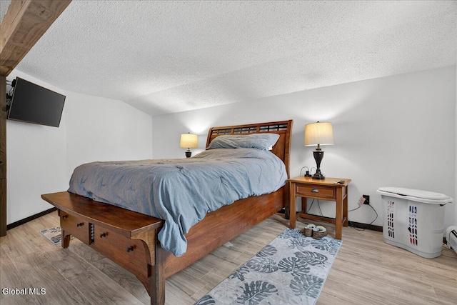 10 Heather Ln, Johnstown, NY 12078 - bedroom featuring a textured ceiling, light wood-type flooring, and vaulted ceiling