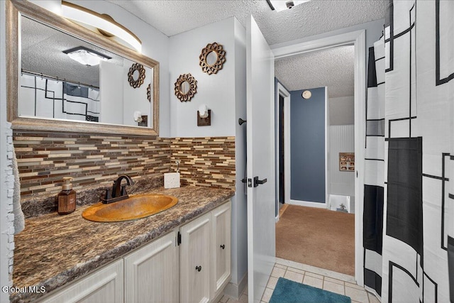 10 Heather Ln, Johnstown, NY 12078 - full bathroom with a textured ceiling, vanity, backsplash, and tile patterned floors