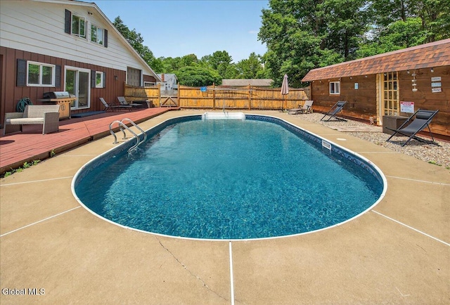 10 Heather Ln, Johnstown, NY 12078 - view of swimming pool with a wooden deck, a fenced backyard, a patio area, and a grill