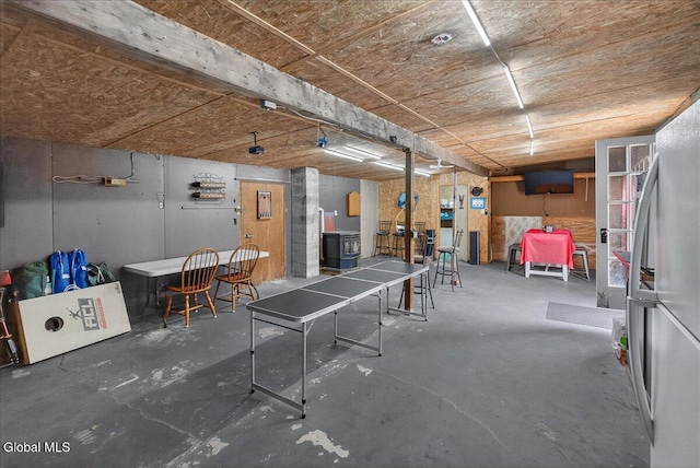 10 Heather Ln, Johnstown, NY 12078 - below grade area featuring a wood stove and freestanding refrigerator