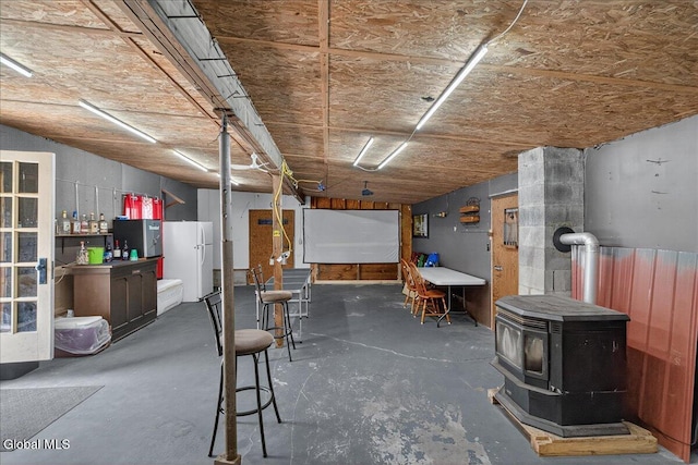 10 Heather Ln, Johnstown, NY 12078 - basement featuring freestanding refrigerator and a wood stove
