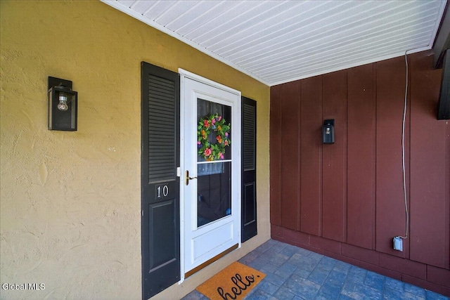 10 Heather Ln, Johnstown, NY 12078 - view of exterior entry with board and batten siding and stucco siding
