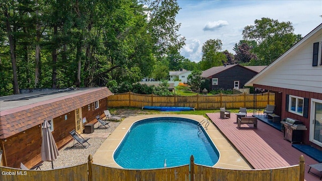 10 Heather Ln, Johnstown, NY 12078 - view of swimming pool with a wooden deck, a fenced backyard, and area for grilling