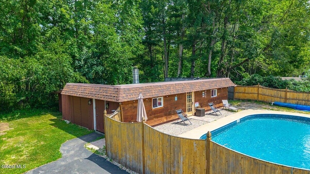 10 Heather Ln, Johnstown, NY 12078 - view of pool with an outdoor structure, a patio, and an exterior structure