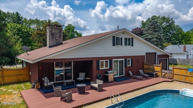 10 Heather Ln, Johnstown, NY 12078 - rear view of house featuring a wooden deck, a fenced backyard, and a chimney