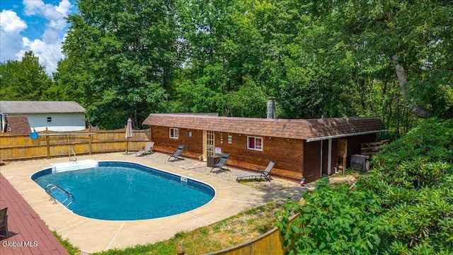 10 Heather Ln, Johnstown, NY 12078 - view of swimming pool with a fenced backyard, a patio, and an outdoor structure