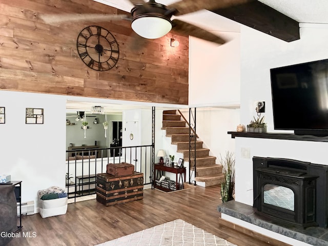 10 Heather Ln, Johnstown, NY 12078 - living room featuring a ceiling fan, wood finished floors, baseboard heating, and a wood stove