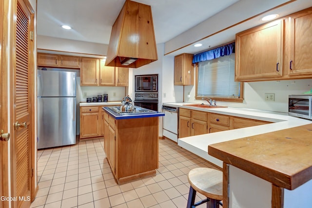 5 Wendfair Ter, Colonie, NY 12205 - kitchen with black appliances, light tile patterned floors, recessed lighting, a kitchen island, and a breakfast bar