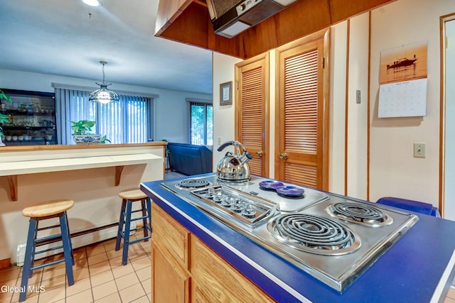 5 Wendfair Ter, Colonie, NY 12205 - kitchen with light tile patterned floors, a breakfast bar area, open floor plan, stainless steel electric cooktop, and hanging light fixtures