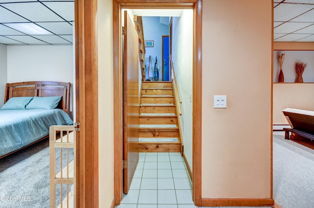 5 Wendfair Ter, Colonie, NY 12205 - hallway with a drop ceiling, light carpet, light tile patterned flooring, and stairs