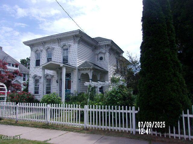20 N 4th Ave, Ilion, NY 13357 - italianate-style house with a fenced front yard
