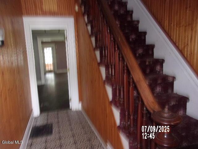 20 N 4th Ave, Ilion, NY 13357 - staircase featuring carpet flooring and wood walls