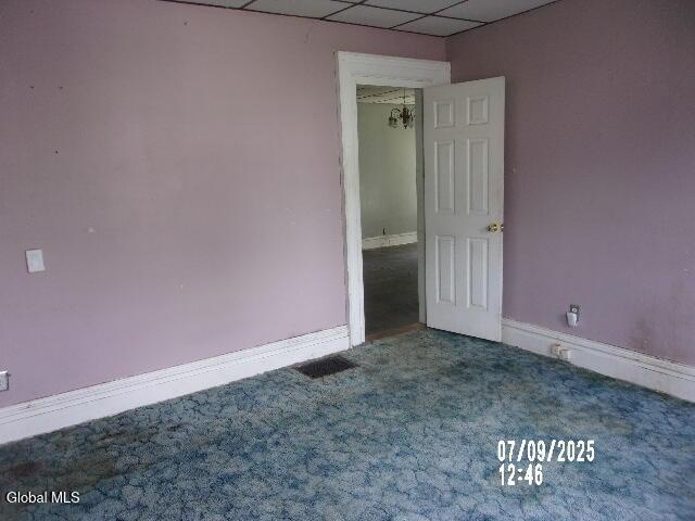 20 N 4th Ave, Ilion, NY 13357 - carpeted empty room featuring a drop ceiling and baseboards