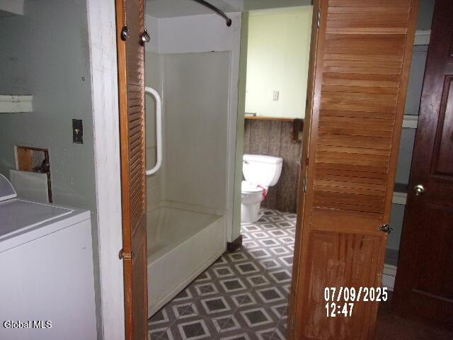 20 N 4th Ave, Ilion, NY 13357 - full bathroom featuring washer / clothes dryer, tile patterned floors, and bathing tub / shower combination
