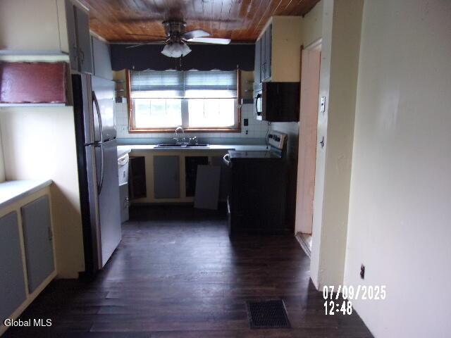 20 N 4th Ave, Ilion, NY 13357 - kitchen featuring freestanding refrigerator, black microwave, stove, a ceiling fan, and wood ceiling