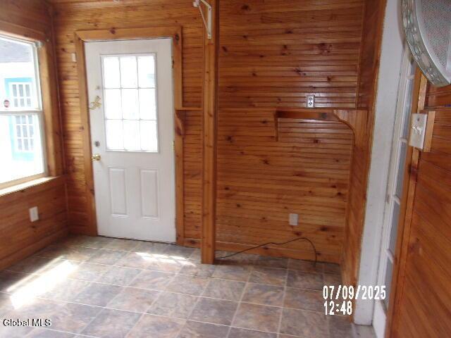 20 N 4th Ave, Ilion, NY 13357 - doorway to outside with wood walls and tile patterned flooring