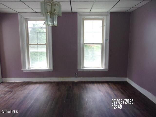 20 N 4th Ave, Ilion, NY 13357 - unfurnished dining area featuring a paneled ceiling, dark wood-style floors, and a chandelier