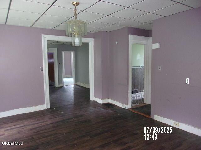 20 N 4th Ave, Ilion, NY 13357 - spare room featuring wood finished floors, a drop ceiling, and a chandelier