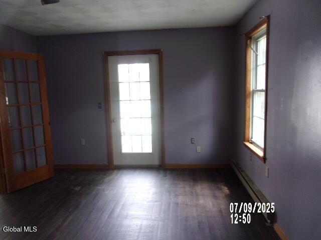 20 N 4th Ave, Ilion, NY 13357 - empty room featuring wood finished floors and a baseboard radiator