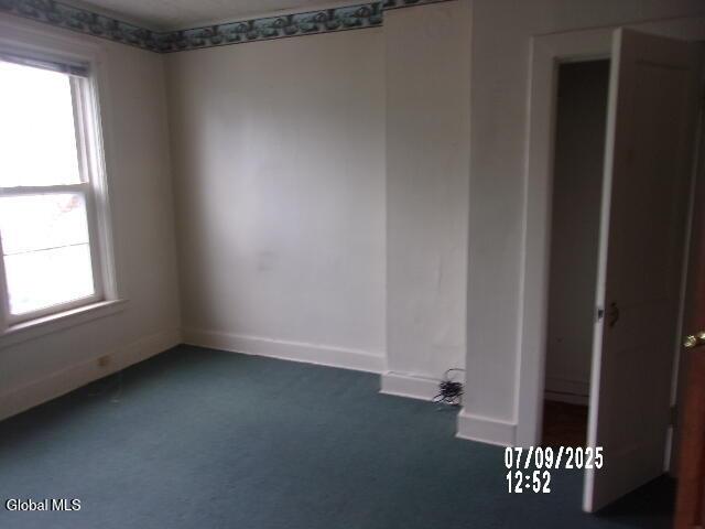 20 N 4th Ave, Ilion, NY 13357 - spare room with plenty of natural light and dark colored carpet