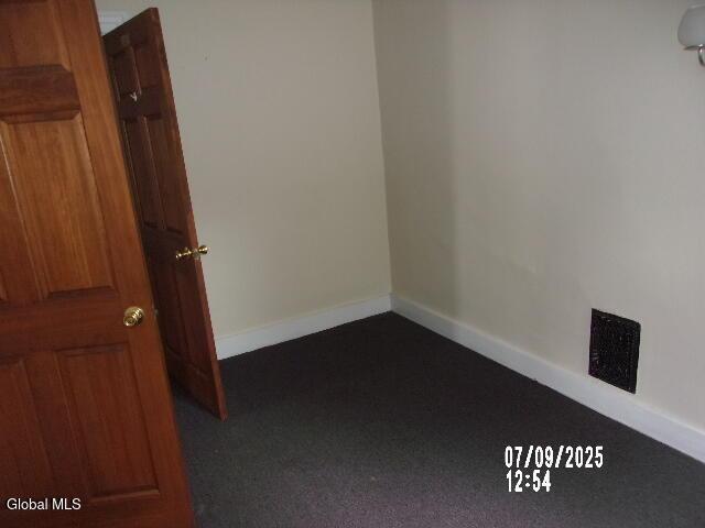 20 N 4th Ave, Ilion, NY 13357 - spare room with baseboards and dark colored carpet