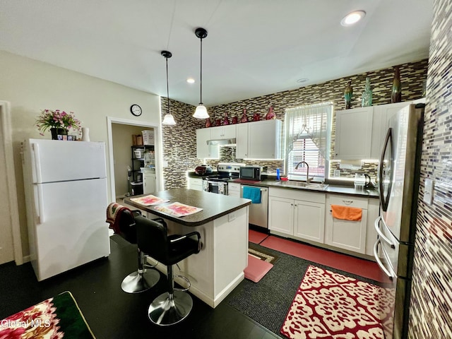 101 Prospect St, Schenectady, NY 12308 - kitchen with stainless steel appliances, dark countertops, white cabinetry, hanging light fixtures, and recessed lighting