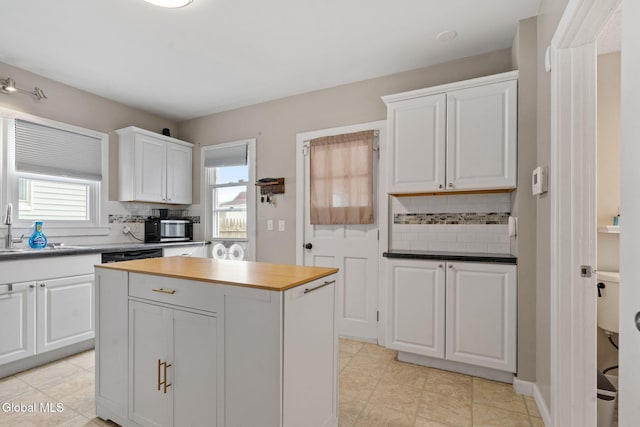 407 Huston St, Scotia, NY 12302 - kitchen featuring backsplash, white cabinets, a center island, and light tile patterned flooring