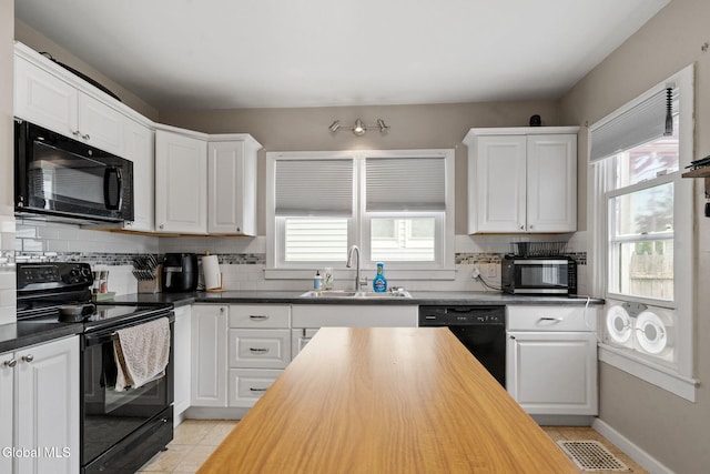 407 Huston St, Scotia, NY 12302 - kitchen featuring black appliances, healthy amount of natural light, wood counters, and white cabinets