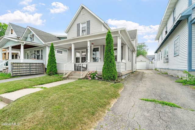 407 Huston St, Scotia, NY 12302 - view of front of house with covered porch, a garage, an outbuilding, and a front lawn