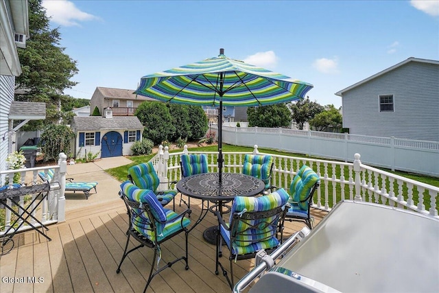 7 Marquette Ave, Colonie, NY 12110 - deck with a fenced backyard, outdoor dining space, and a storage shed